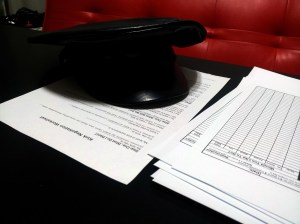 Some paperwork and my Domme hat