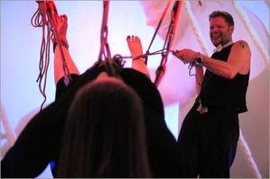 Monk (no last name) laughs as he suspends Sam D. using bondage rope made of 100% hemp during
